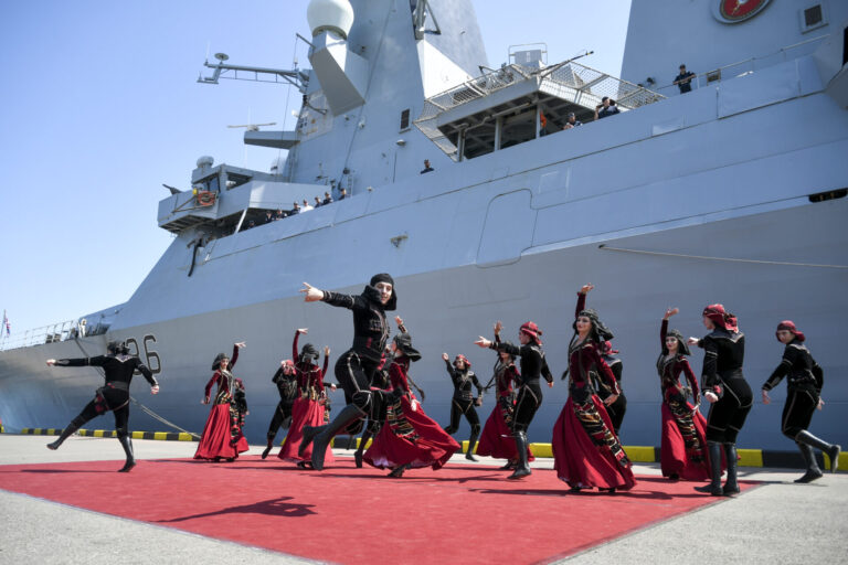 Georgians wearing national costumes dance in front of the British destroyer, HMS Defender, upon its arrival at the port of Batumi in June 2021. “The British naval presence in the Black Sea has grown to uphold freedom of navigation and remind the Kremlin that the annexation of Crimea is not a done deal,” James Rogers writes.